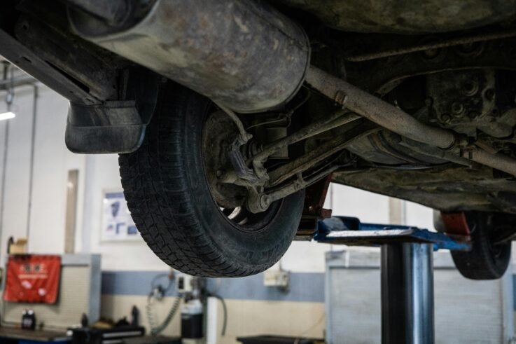 Technician performing wheel alignment service on a vehicle at Union Auto Service in Union, NJ.