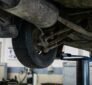 Technician performing wheel alignment service on a vehicle at Union Auto Service in Union, NJ.